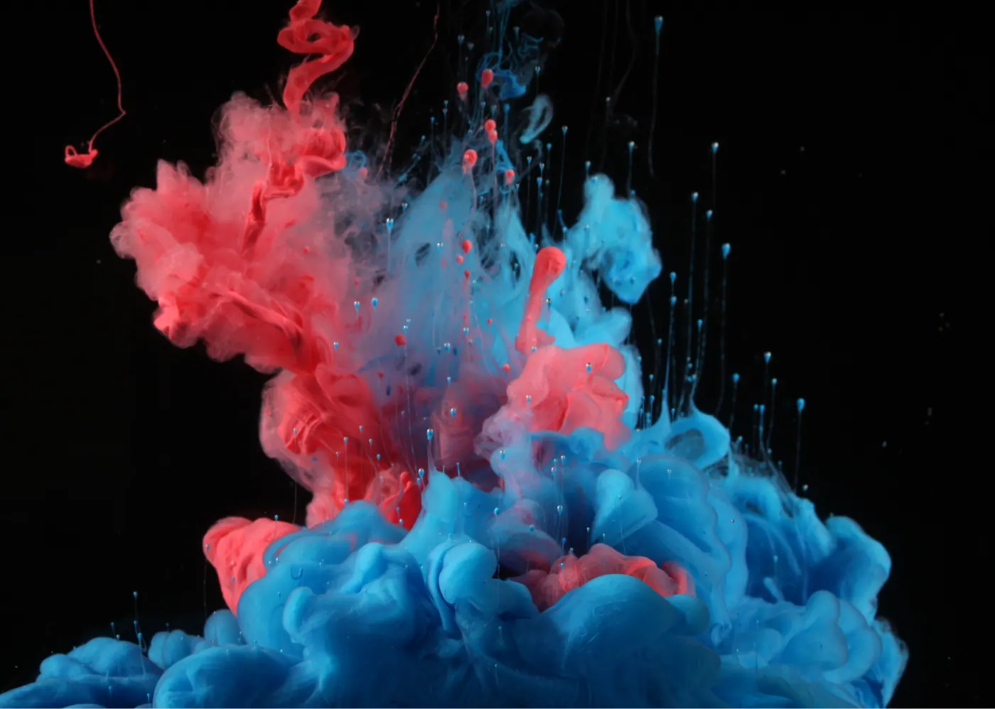 Red and blue ink smoke on black background
